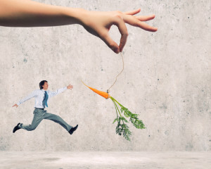 carrot dangled in front of man running, used in blog How to get employees invested in your business goals